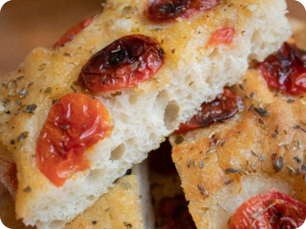 close-up photo of a focaccia with cherry tomatoes on it